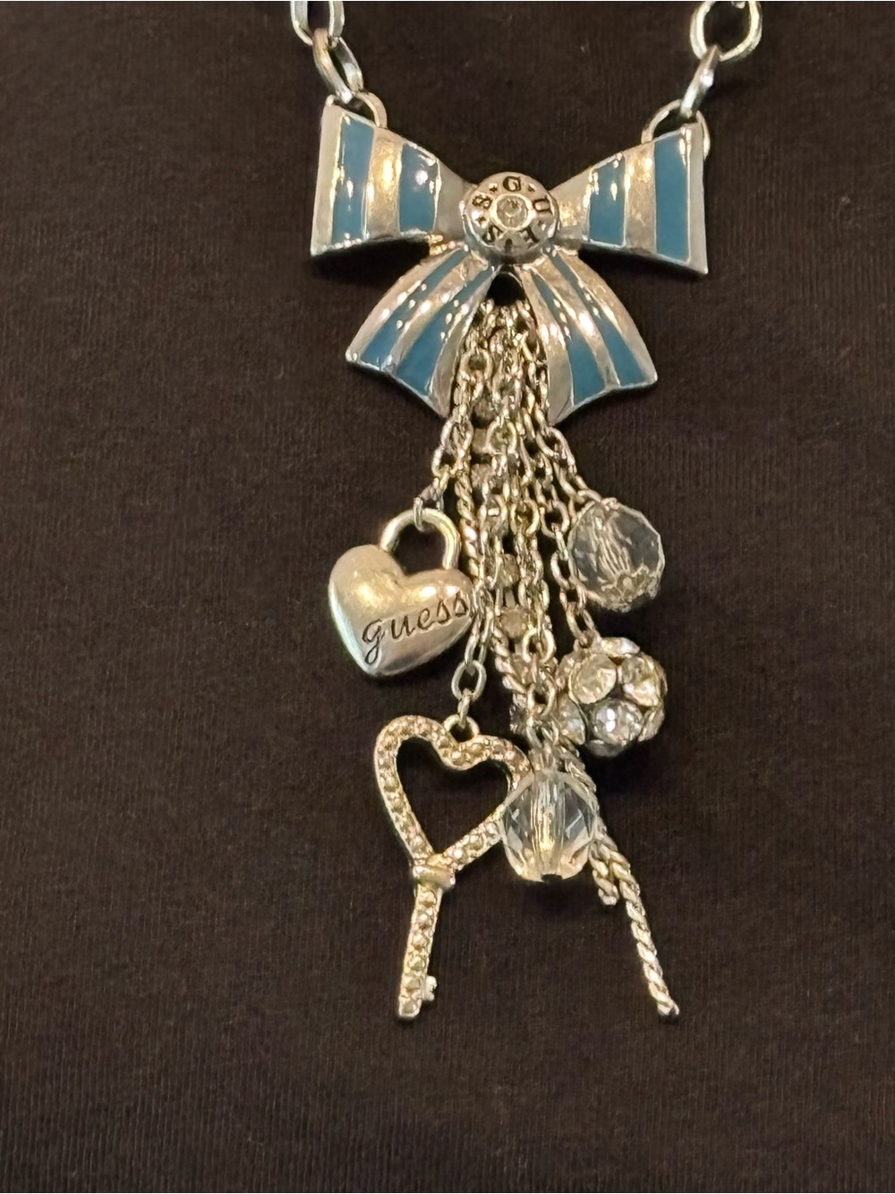 GUESS Silver and Light Blue Enamel Bow Charm Necklace with Heart and Key Drops